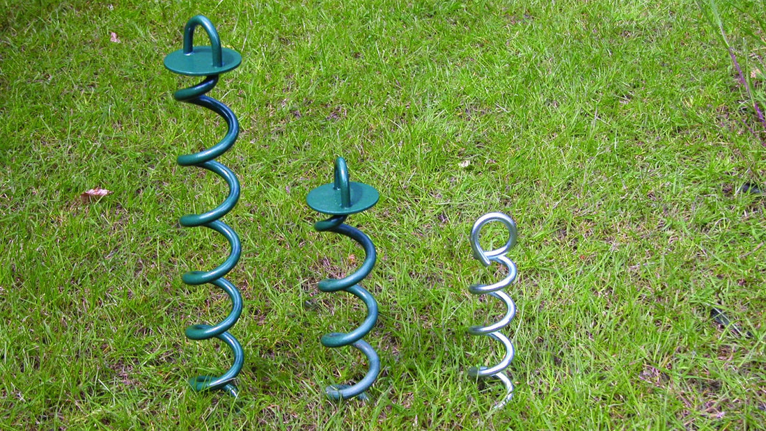 Ground Anchors of Differing Sizes Partially driven in to grass
