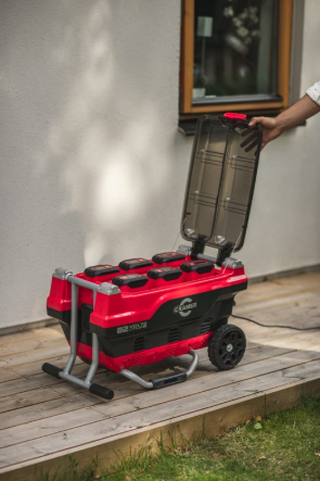 Red and Black Cramer 82V Professional 6 Slot Rapid Charging Station in use