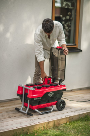 Red and Black Cramer 82V Professional 6 Slot Rapid Charging Station in use
