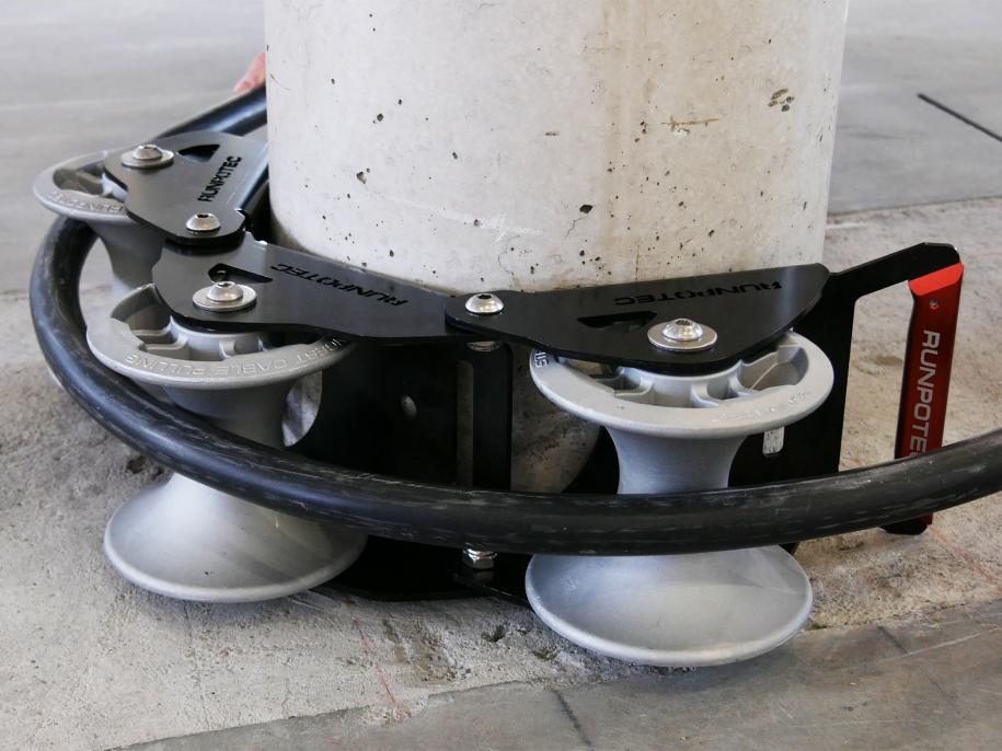 The Runpotec cable guide roller can be used for pulling cables gently around corners with the least possible resistance - example picture showing SWA cable running around a concrete post 